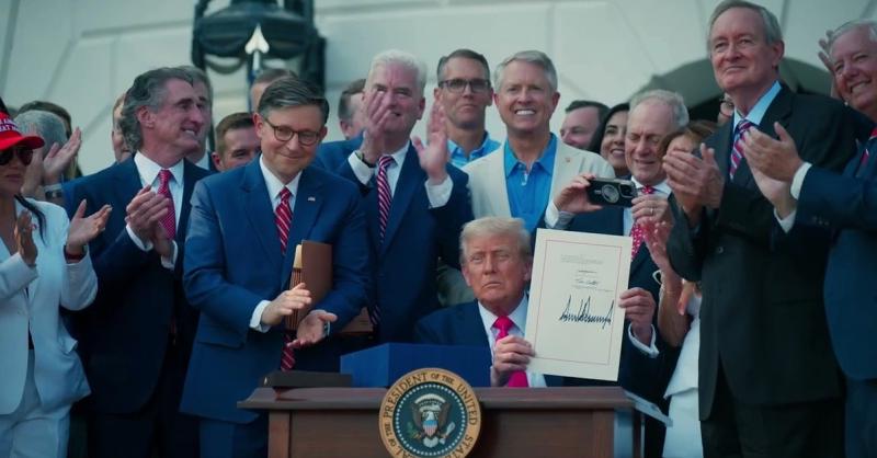 President Trump holds up the signed One Big Beautiful Bill on the South Lawn, surrounded by cheering lawmakers — the law that delivered No Tax on Tips (Official White House video still, “Americans across the country are thanking President Trump for delivering on No Tax on Tips,” posted Oct. 4, 2026)