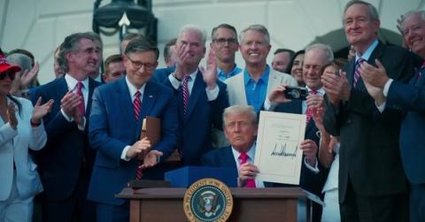 President Trump holds up the signed One Big Beautiful Bill on the South Lawn, surrounded by cheering lawmakers — the law that delivered No Tax on Tips (Official White House video still, “Americans across the country are thanking President Trump for delivering on No Tax on Tips,” posted Oct. 4, 2026)