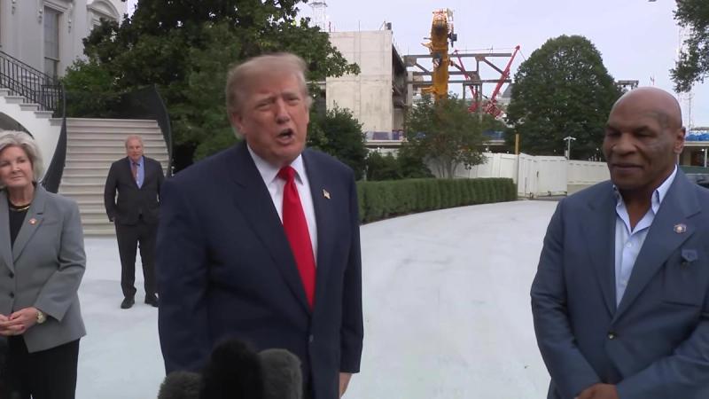 President Trump speaks to reporters with Mike Tyson beside him as he departs the White House, October 9, 2026 (still from Official White House video)