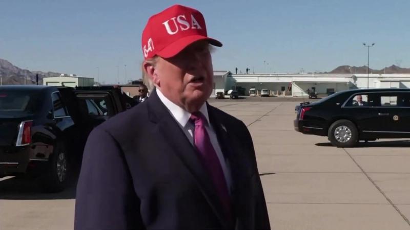 President Trump, in a red USA cap, answers reporters' questions on the tarmac in Bullhead City, Arizona, October 14, 2026 (still from Rapid Response 47 video)