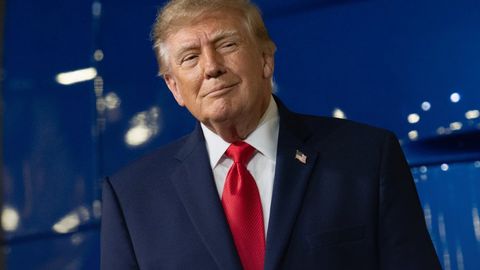 President Donald J. Trump smiles in front of a blue backdrop. (White House "Recent Wins" image, text cropped out)