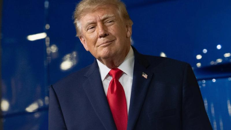 President Donald J. Trump smiles in front of a blue backdrop. (White House "Recent Wins" image, text cropped out)