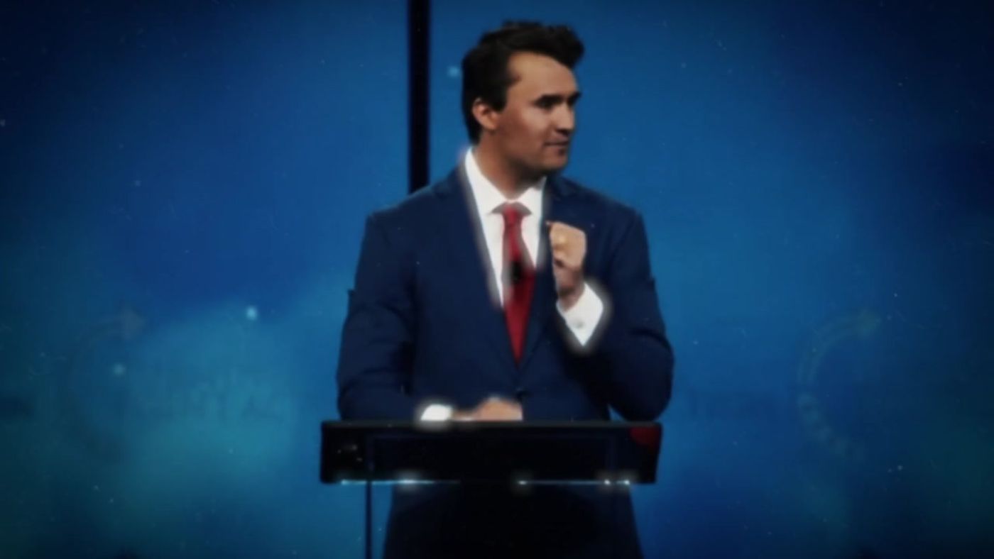 Charlie Kirk speaks at a podium on stage, from the White House tribute video posted October 14, 2026