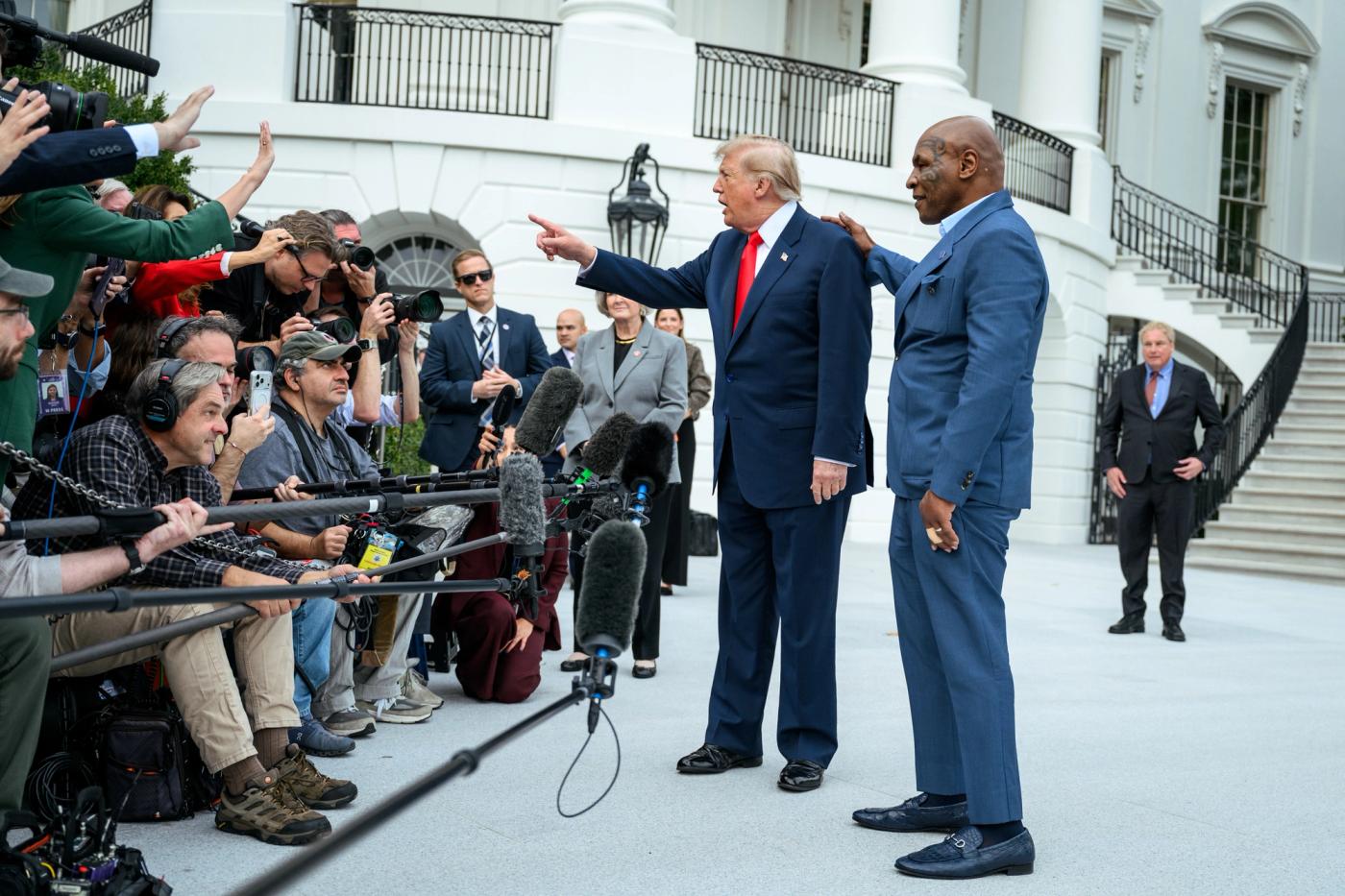 Stand-in photo (October 9, 2026): President Donald J. Trump speaks with members of the media alongside Mike Tyson before boarding Marine One on the South Lawn of the White House, Friday, October 9, 2026, en route to Joint Base Andrews for a trip to Syracuse, New York. (Official White House Photo by Joyce N. Boghosian)