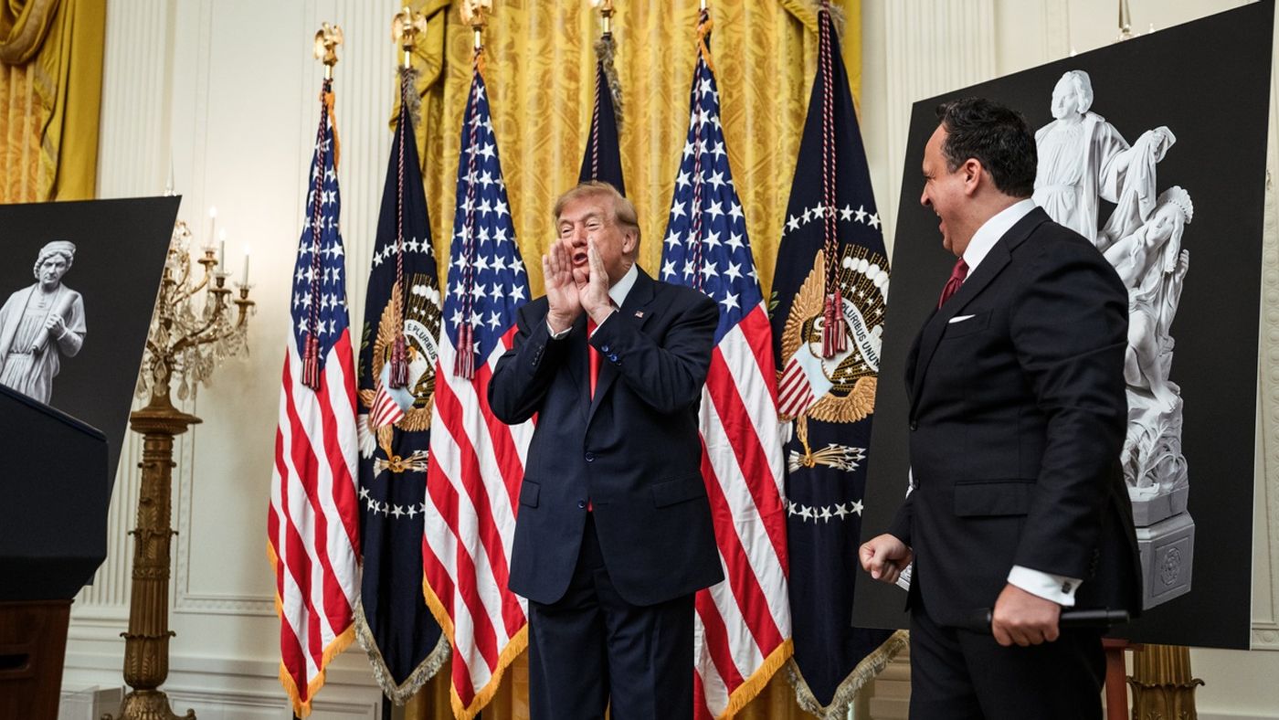 President Trump at the White House Columbus Day celebration with Christopher Columbus statue posters and presidential flags, October 2026 (Official White House photo)