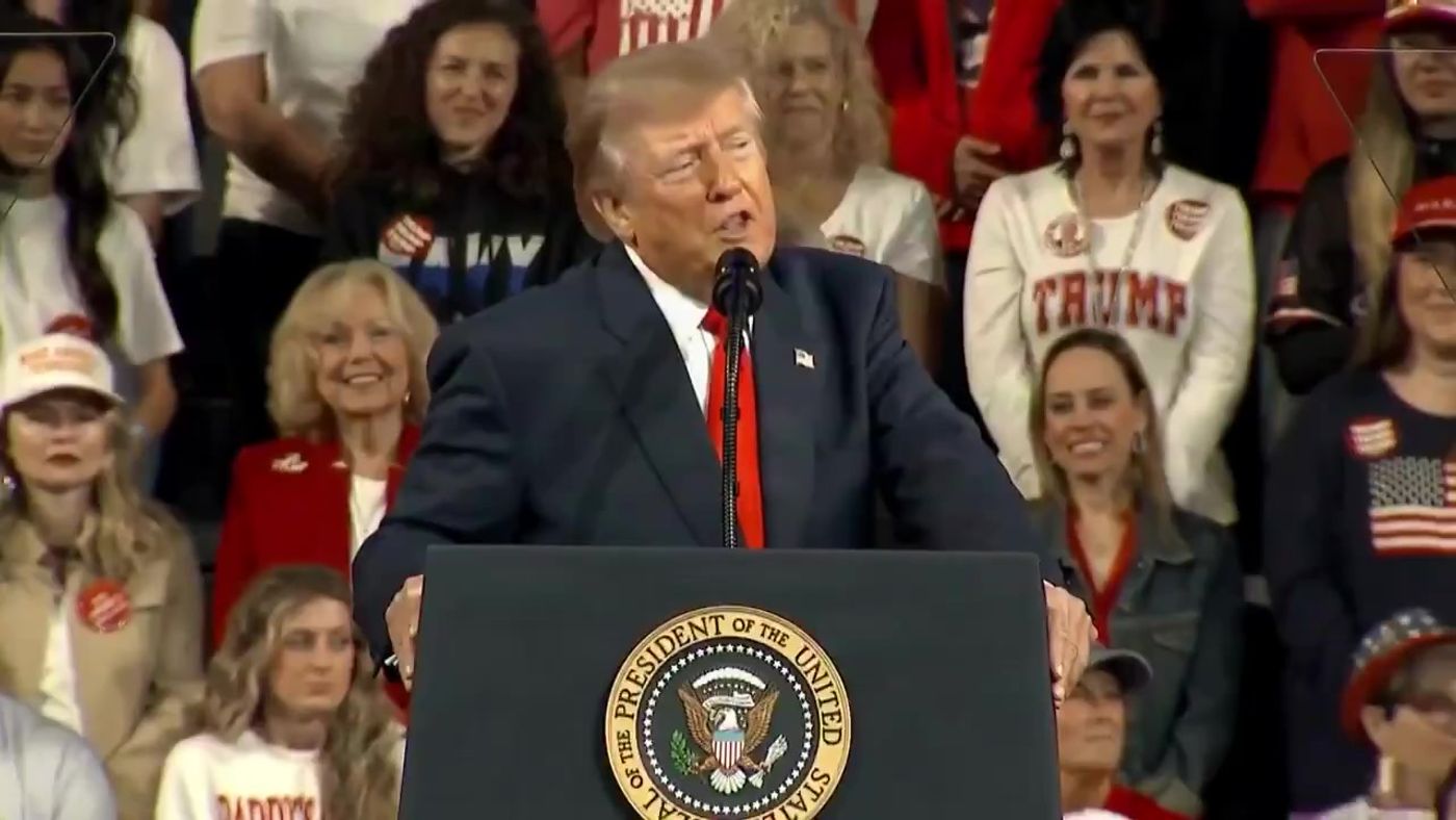 President Trump speaks at the presidential lectern about Obamacare refund checks and rural hospitals as supporters stand behind him at his rally in Tennessee, October 10, 2026 (still from Official White House video)