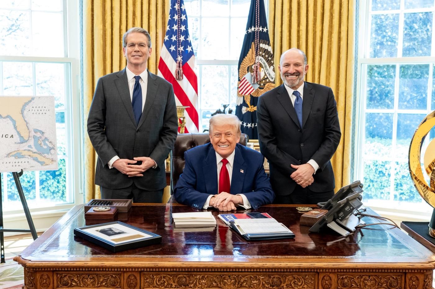 President Trump seated at the Resolute Desk in the Oval Office with Treasury Secretary Scott Bessent and Commerce Secretary Howard Lutnick, April 9, 2025 (Official White House / U.S. government work). Prior Oval still used because the September 30, 2026 announcement gallery is not posted yet.