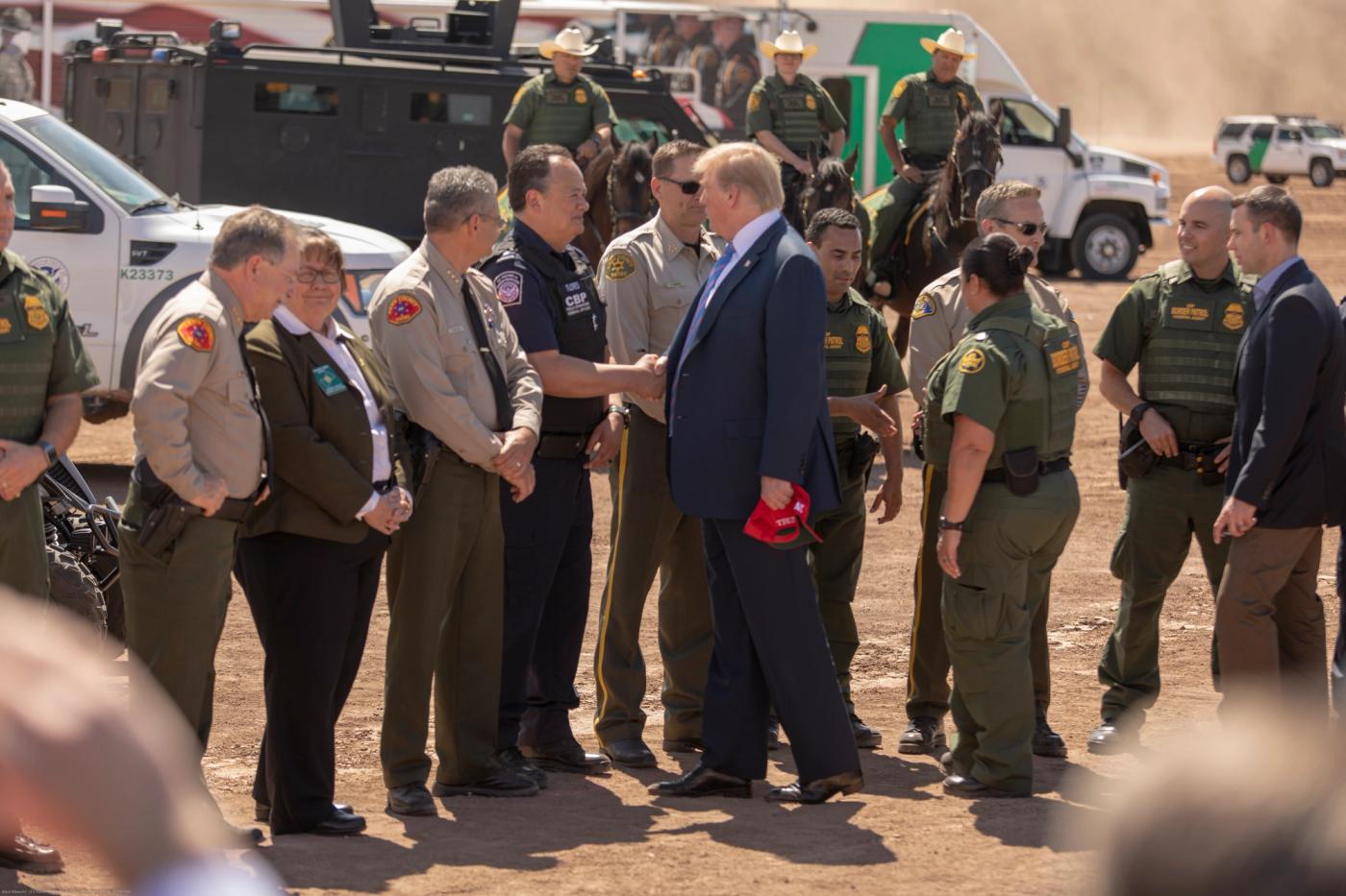 President Donald Trump visits a newly installed section of border wall near Calexico, California, April 5, 2019, with DHS and Border Patrol officials. U.S. Customs and Border Protection photo by Mani Albrecht (public domain).