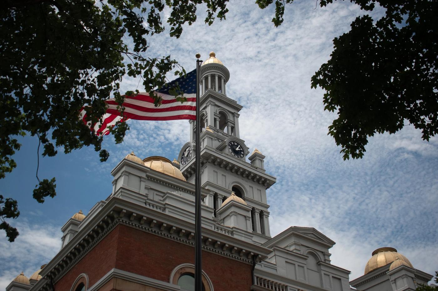 Stand-in photo (July 6, 2024): The Sevier County Courthouse in Sevierville, Tennessee, with the flag of the United States waving in the foreground (CC0 / public domain dedication)