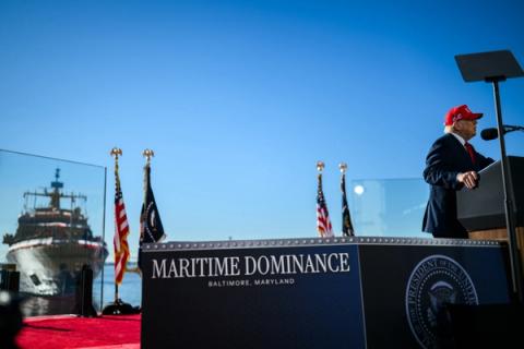 President Trump delivers remarks with the ship moored behind the stage at Sparrows Point Shipyard in Baltimore, Maryland, where Anduril Industries will build a submarine and autonomous vessel shipyard, October 6, 2026 (Official White House Photo by Daniel Torok)