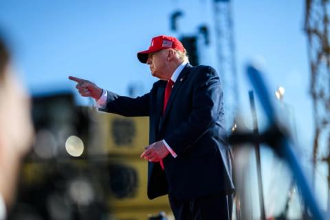 President Donald J. Trump, wearing a red USA hat, points while speaking at the Sparrows Point shipyard in Baltimore, Maryland, during remarks on American shipbuilding and defense manufacturing, October 6, 2026. (Official White House Photo by Daniel Torok)