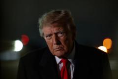 President Donald J. Trump, in a dark suit and red tie, photographed at night. (Official White House Photo by Molly Riley, Departure and Arrival gallery, October 10, 2026)