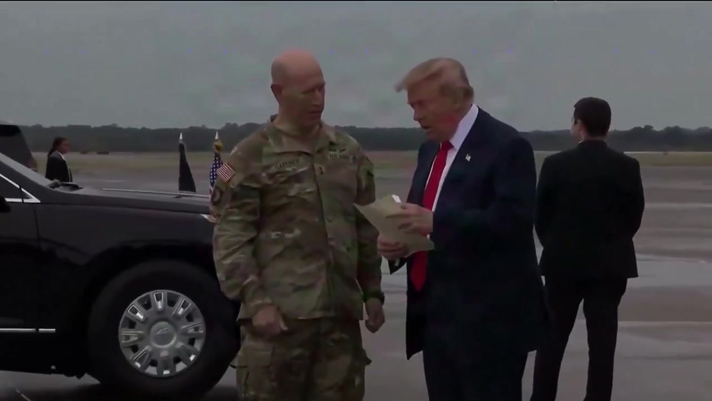 President Trump speaks with a U.S. Army soldier on the tarmac after arriving at Fort Campbell, October 10, 2026 (still from Official White House video)