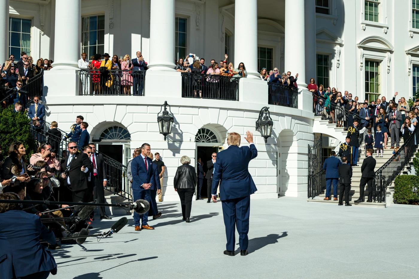 President Trump waves to guests on the Truman Balcony before boarding Marine One on the South Lawn of the White House en route to Sparrows Point, Maryland, October 6, 2026 (Official White House Photo by Molly Riley)