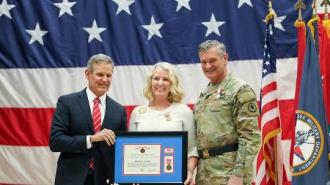Rhonda M. Holmes poses for a photo with Gov. Bill Lee, Tennessee State Governor, after he awarded her the Meritorious Service Medal at Joint Force Headquarters, Nashville, Tenn., March 3, 2023 (U.S. Army National Guard photo by Spc. Kalina Hyche)