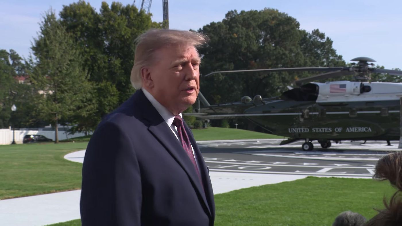 President Donald J. Trump speaks with the press on the South Lawn, with Marine One behind him, as he departs the White House for Mobile, Alabama, Friday, October 2, 2026 (frame from the official White House video of the departure gaggle).