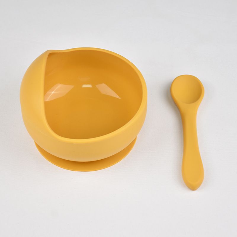 Raised contoured scoop lip design on silicone toddler training bowl