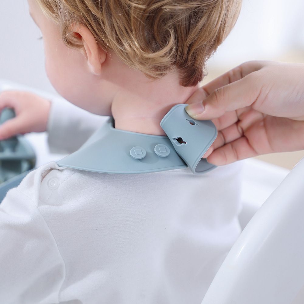 Adjustable neckband with reinforced buttons on printed silicone toddler bib