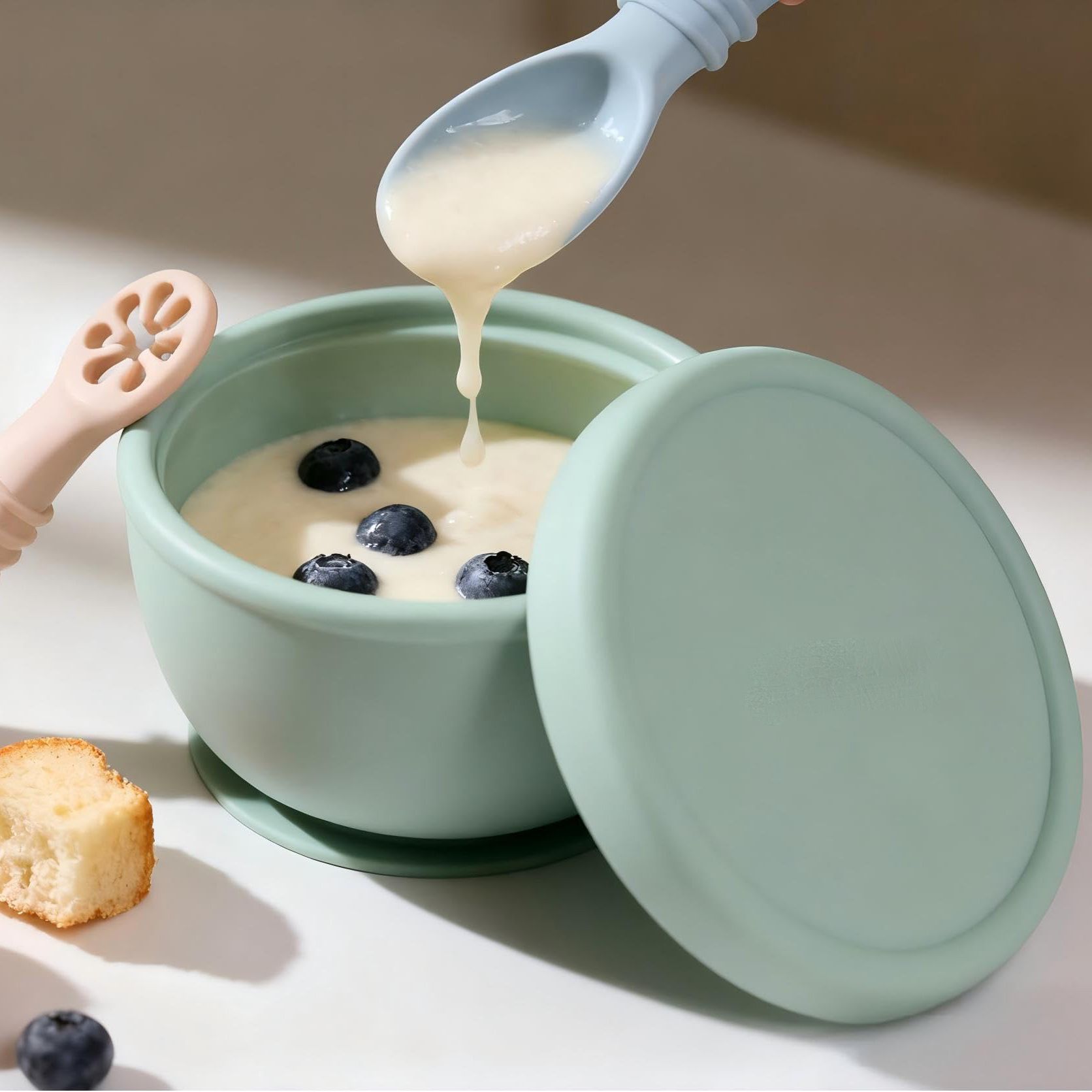 Multiple pastel colors of silicone baby feeding bowls with lids
