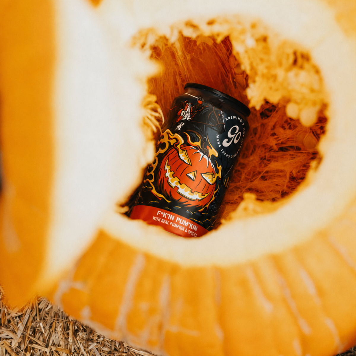 Go Brewing's F*k'in Pum'kin non-alcoholic ale can inside a cut-open pumpkin.