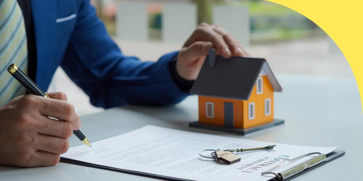 Person signing a contract beside a small model house and a set of keys