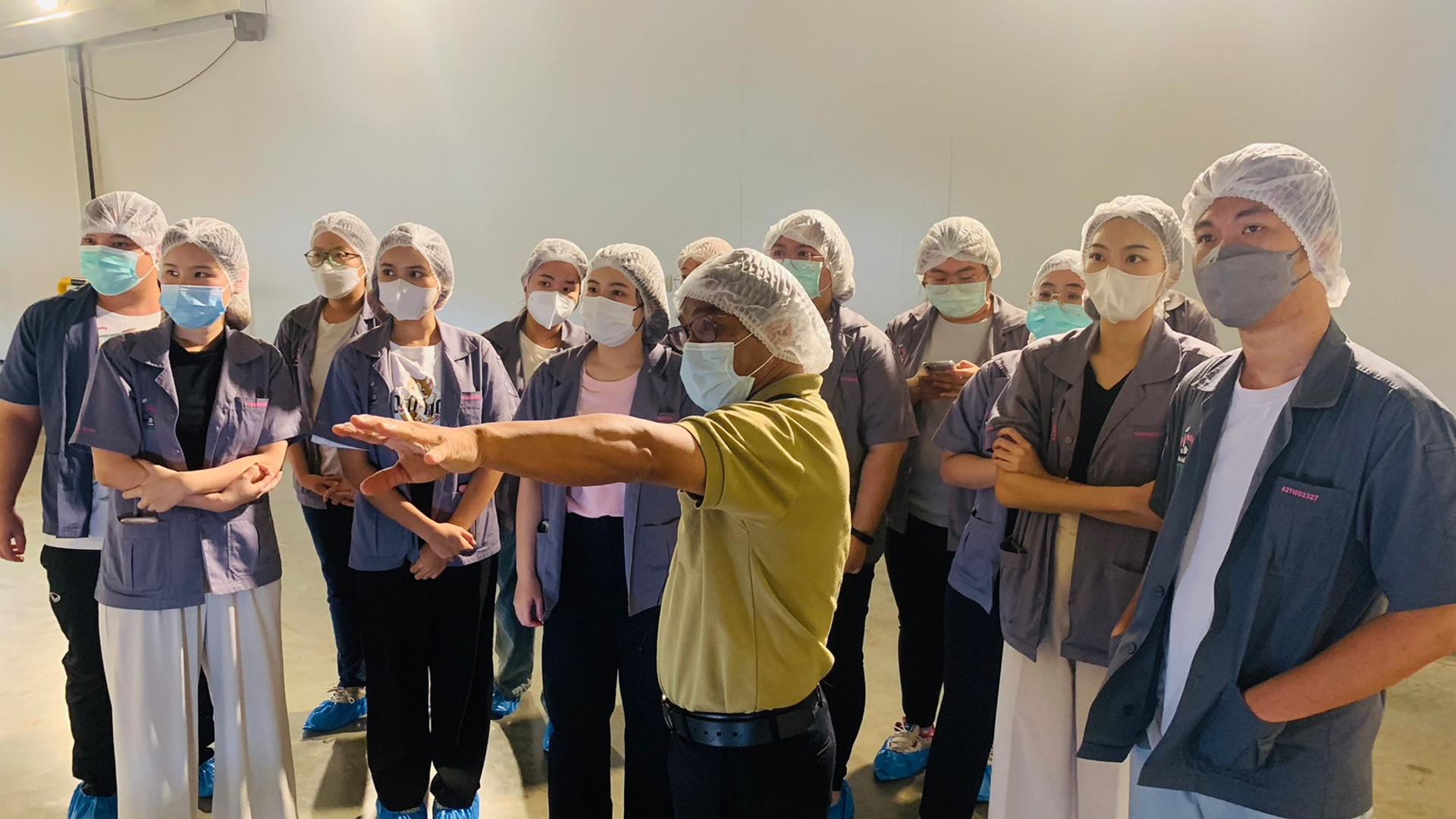 Students listening to a lecture in the factory