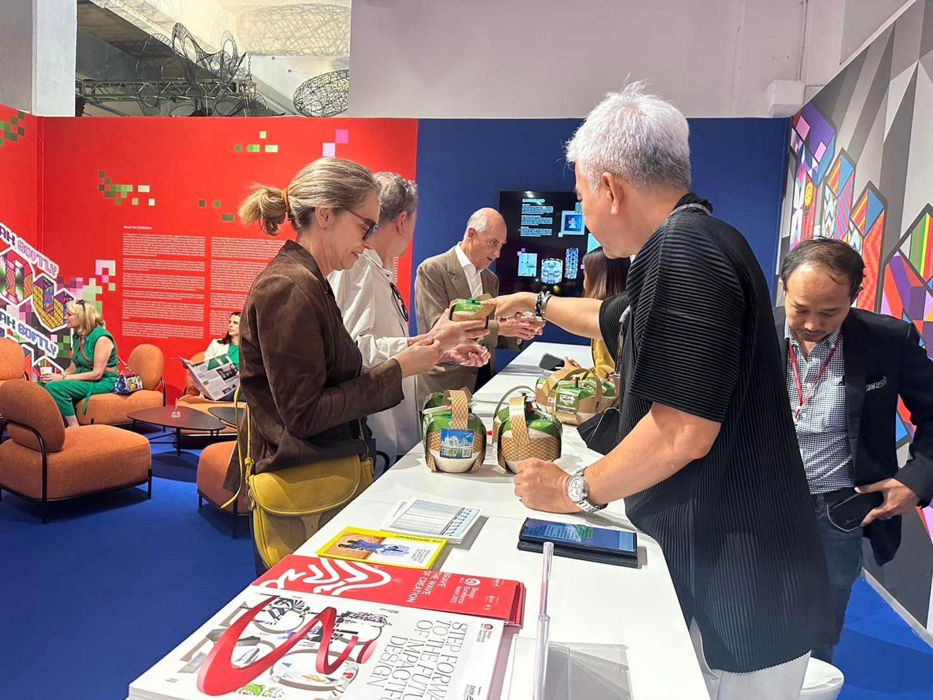 People stand and admire coconut water from K-Fresh.