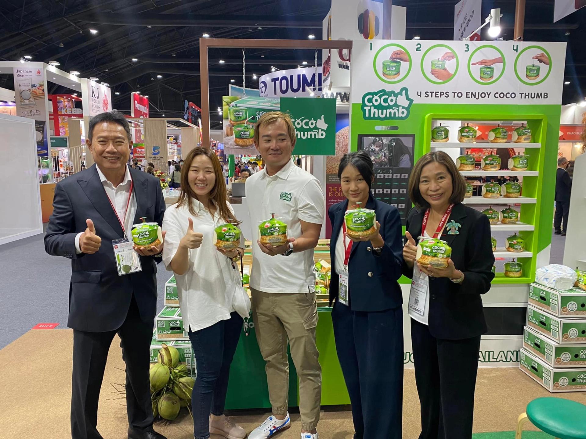 5 people holding coconuts from k fresh