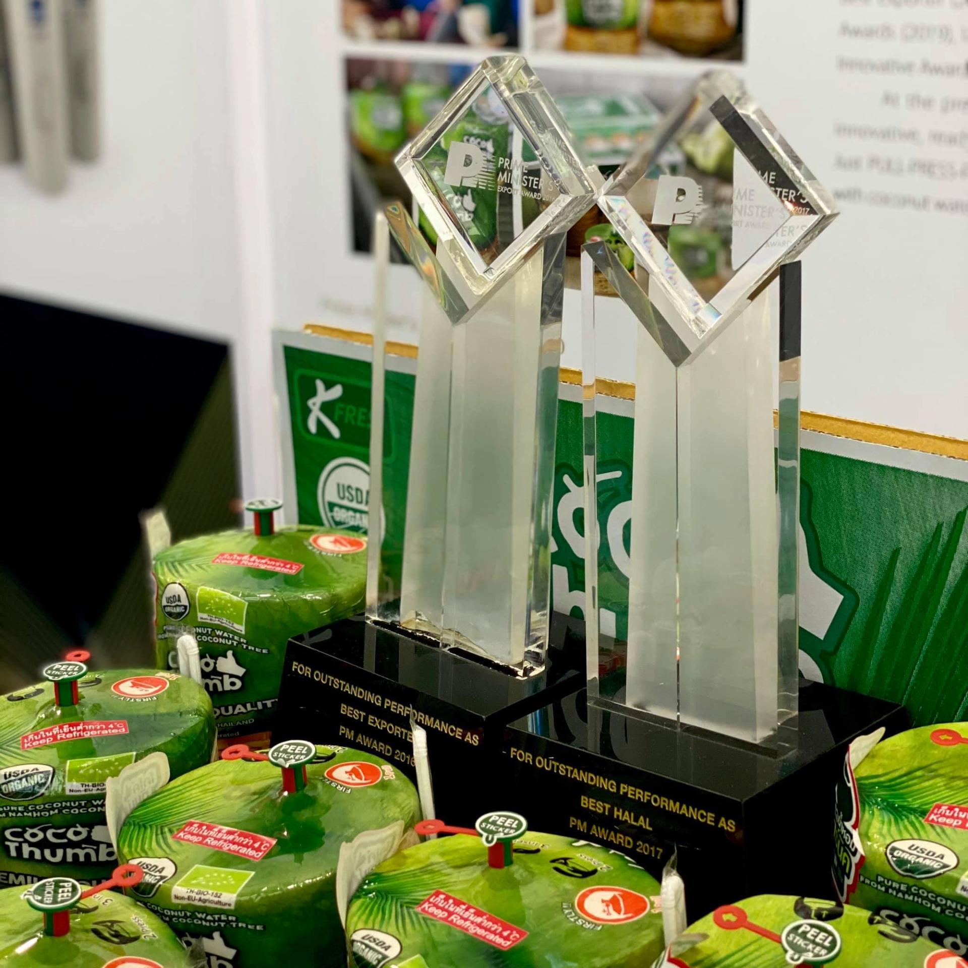 The trophy is set among the coconuts.