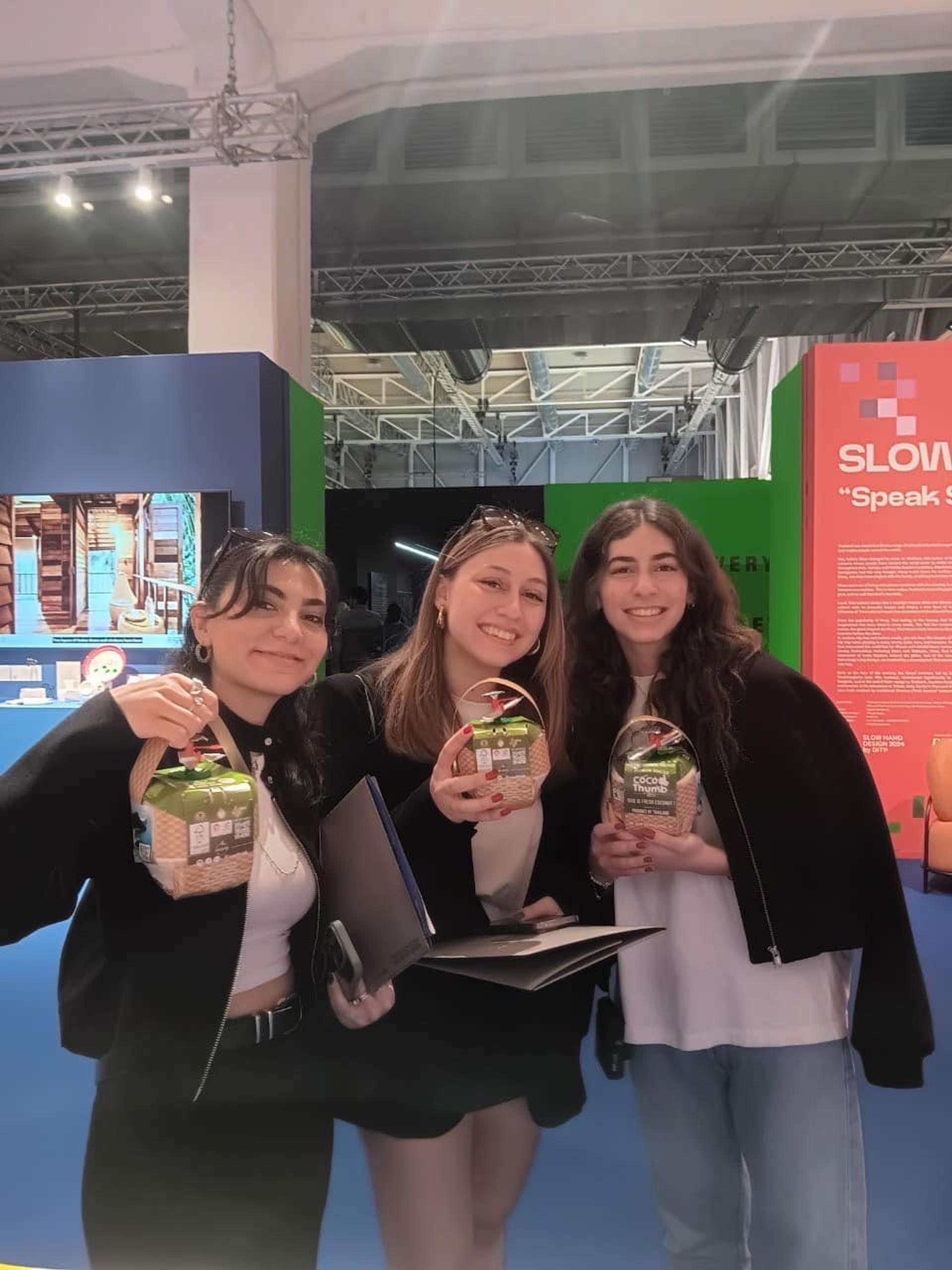 Three women holding coconut water