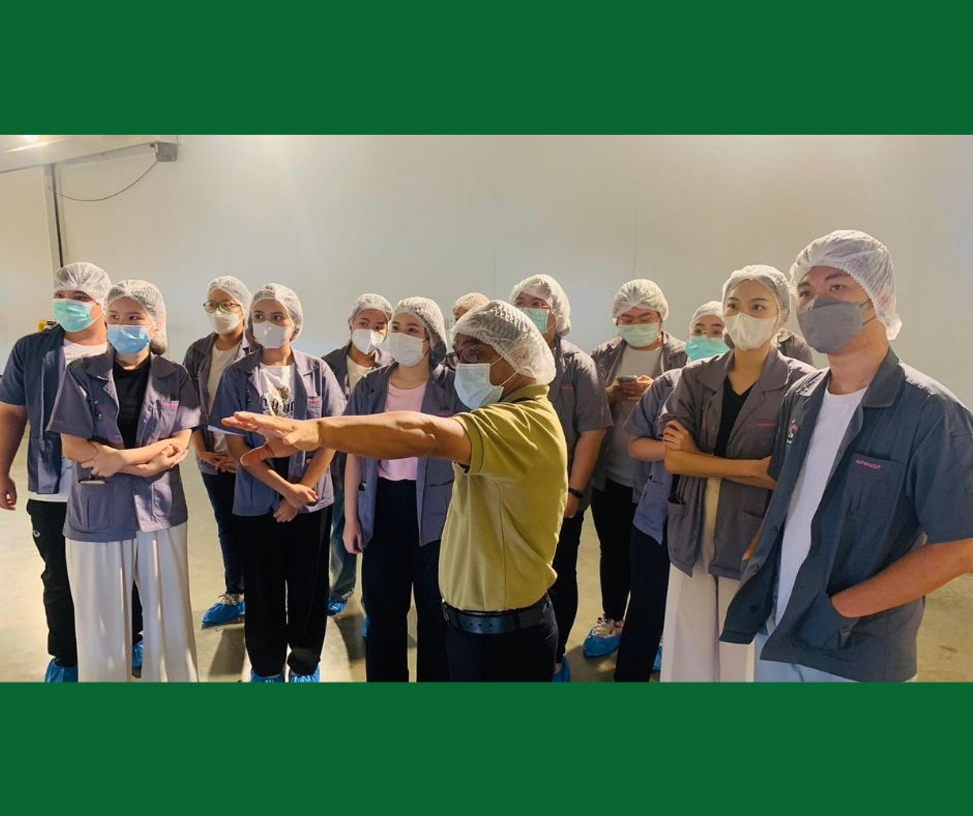 Students listening to a lecture in the factory