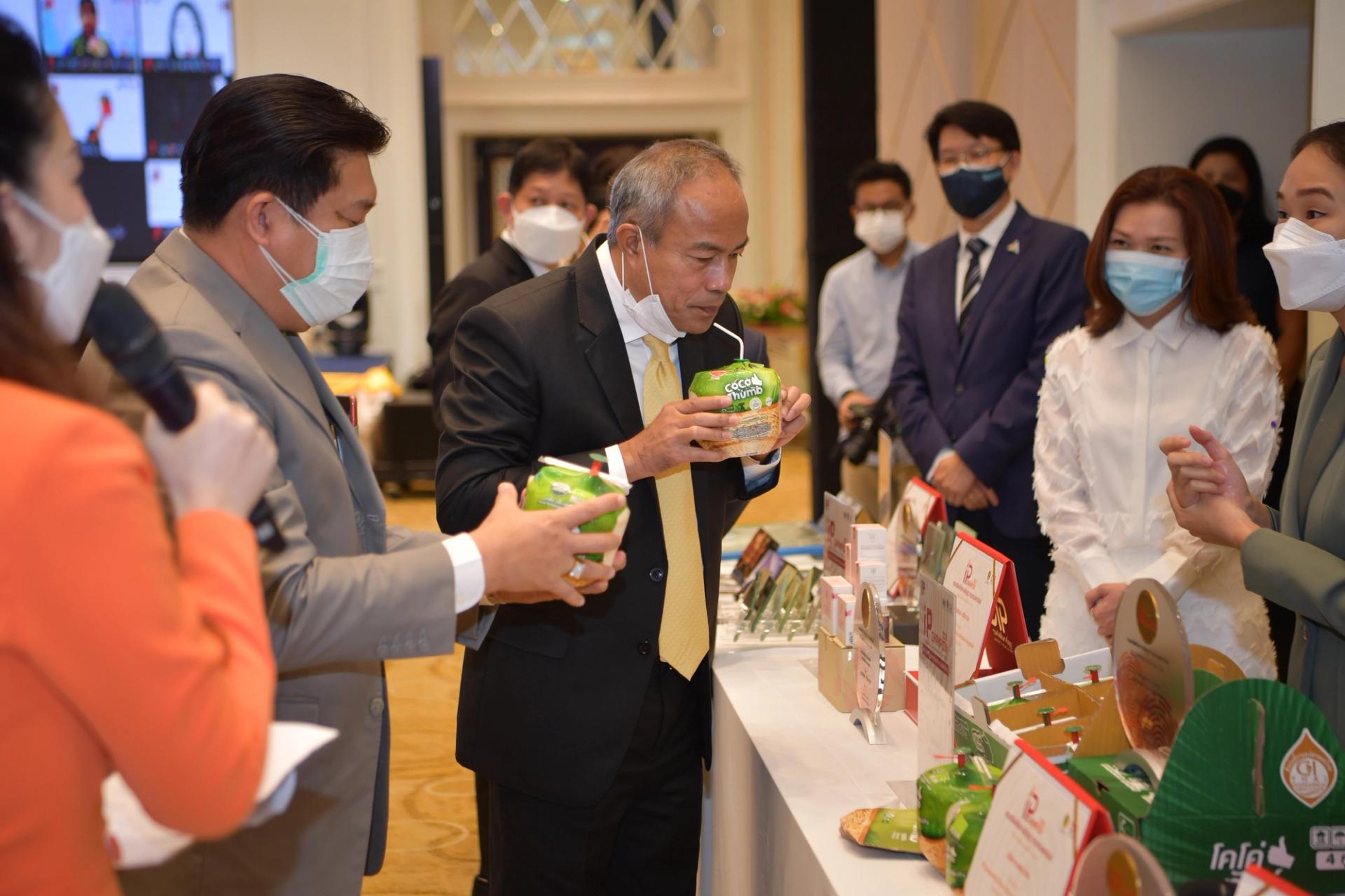 Exhibition visitors try the coco thumb drink.