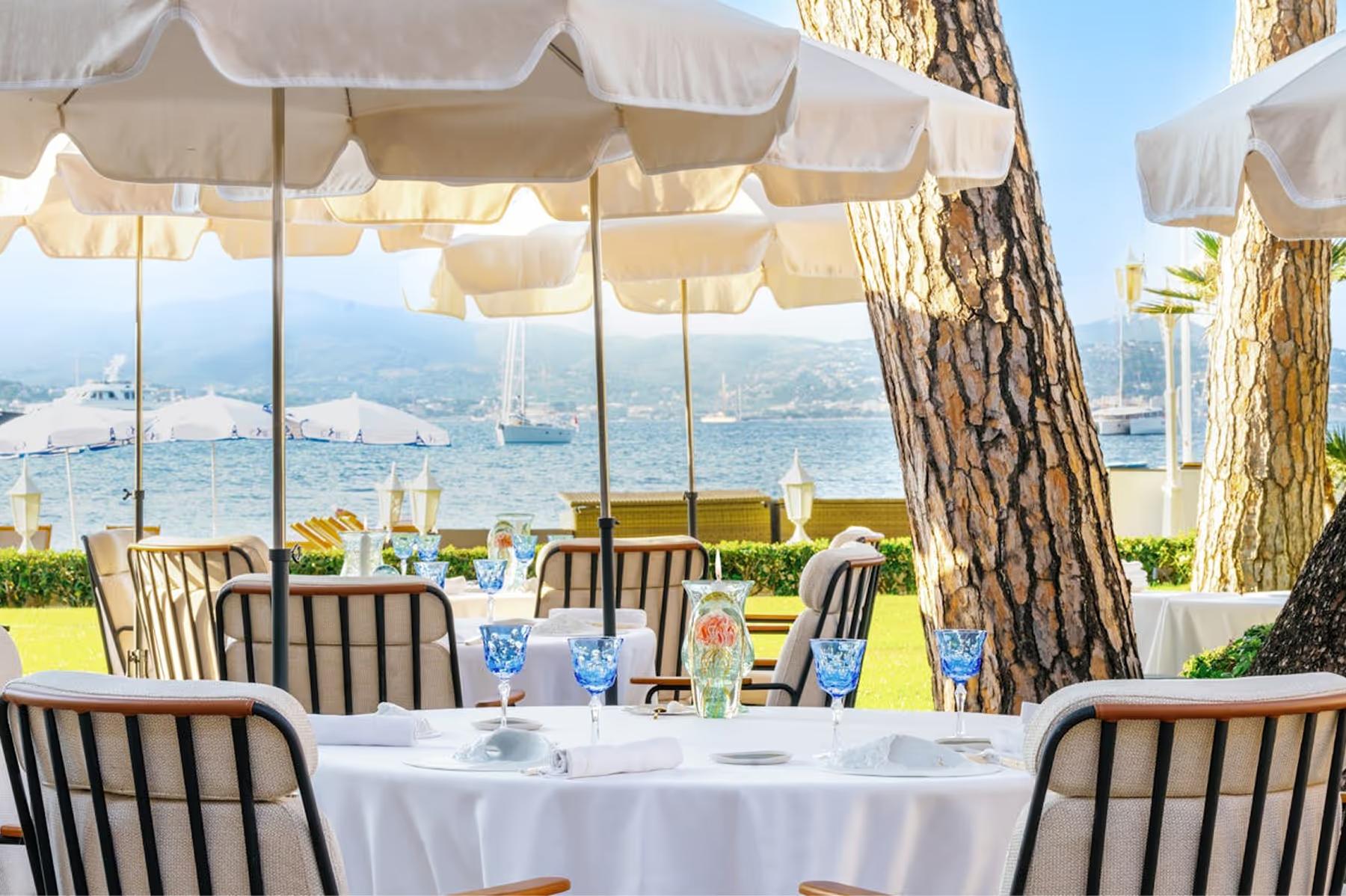 Cheval Blanc St-Tropez: shaded outdoor dining set under trees with water vista