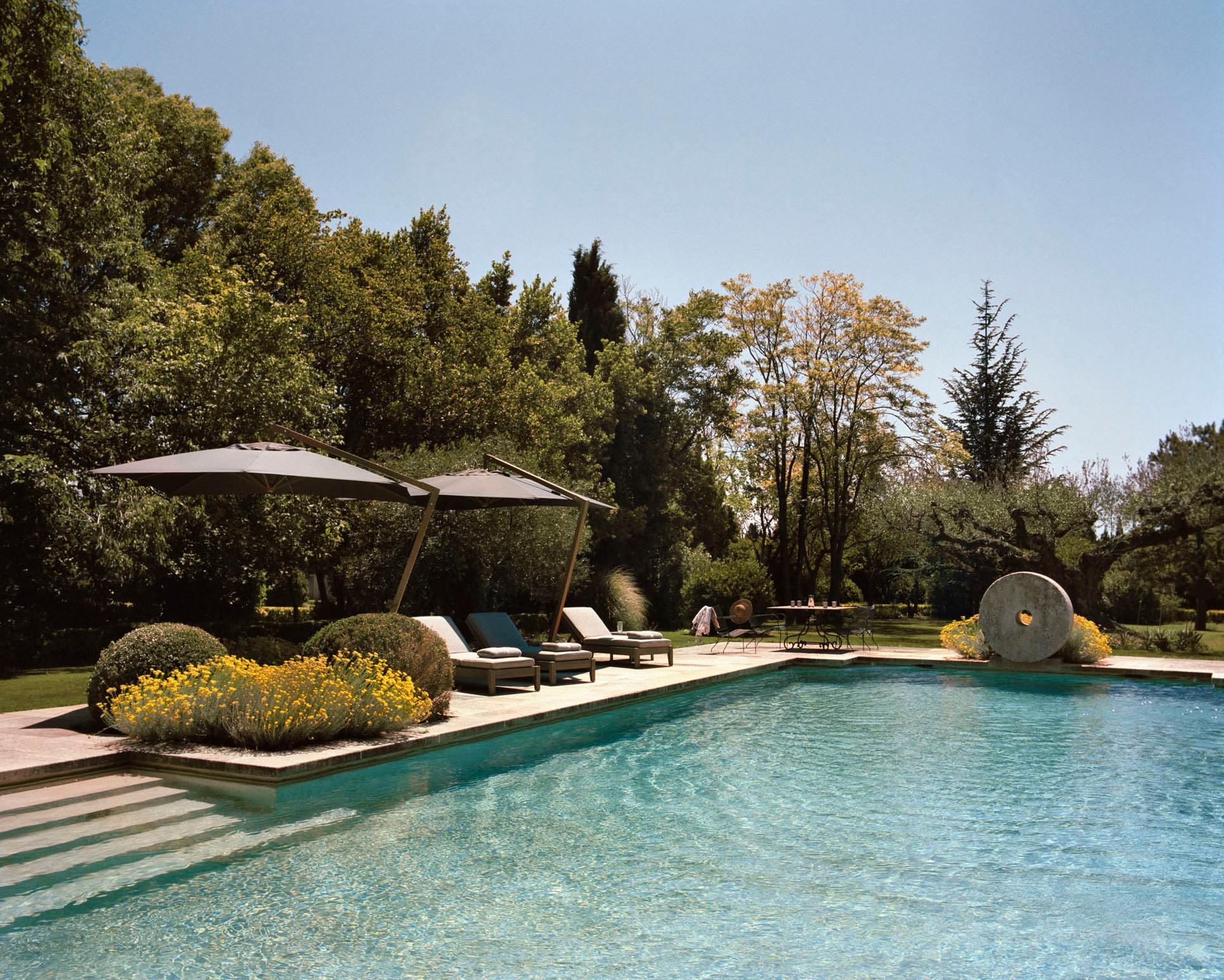 Le Mas de Chabran: heated saltwater pool with loungers and umbrellas surrounded by mature landscaping