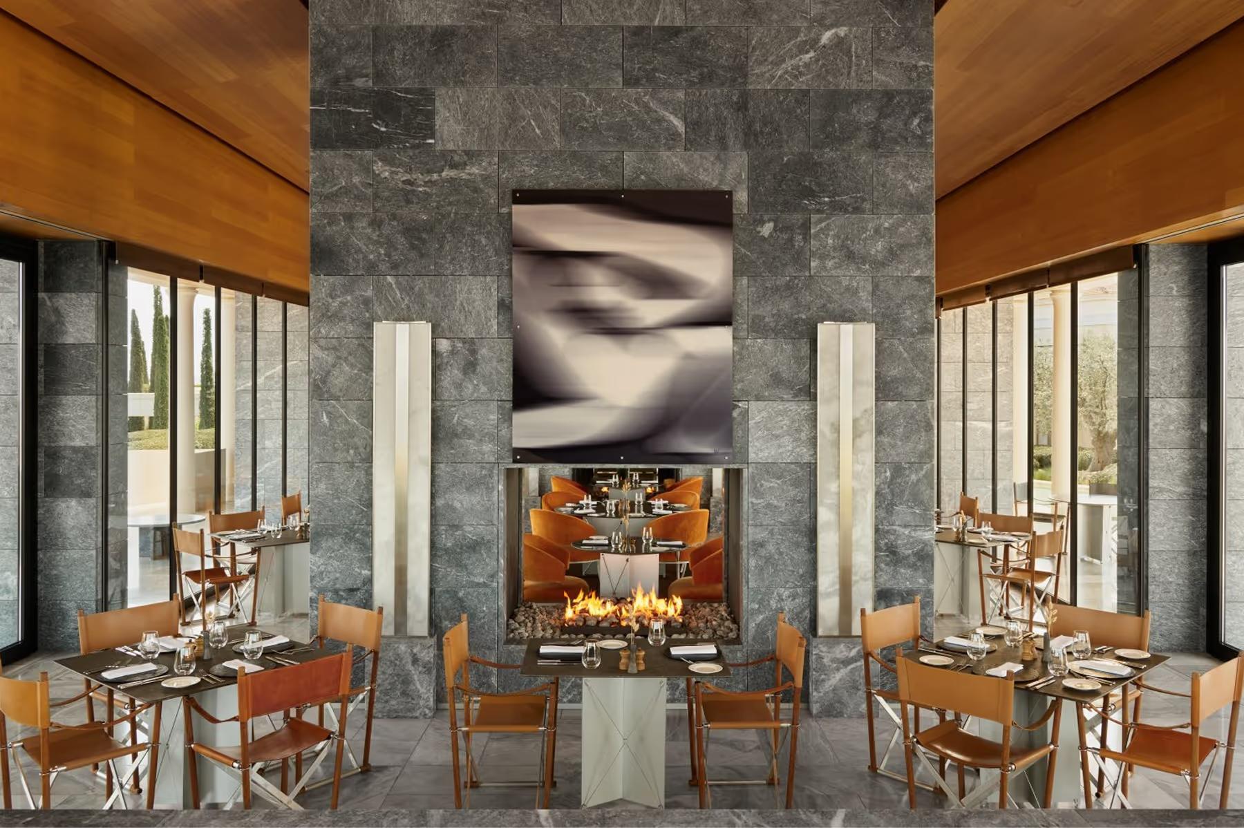 Amanzoe: contemporary dining space with marble walls and warm wood accents