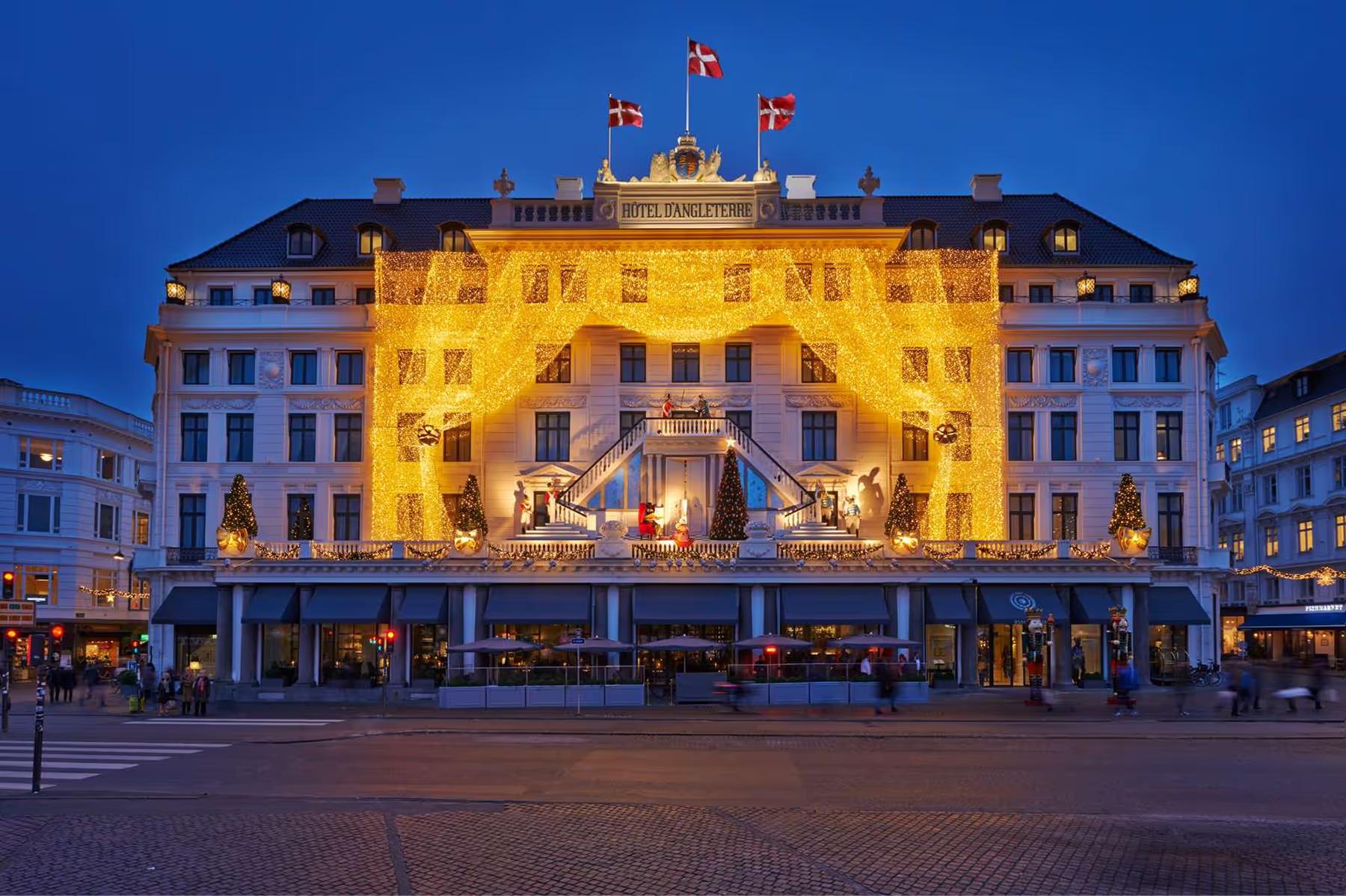 Hotel d’Angleterre: historic building illuminated at night on town square in Copenhagen