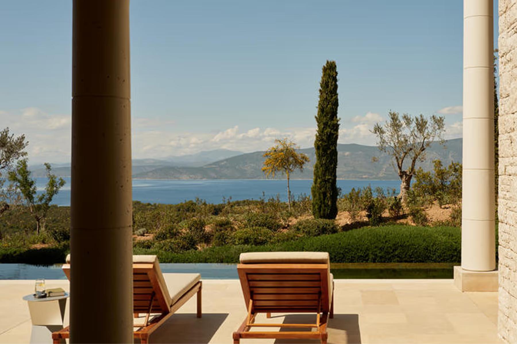Amanzoe: seafront lounge area with daybed chairs and expansive water views