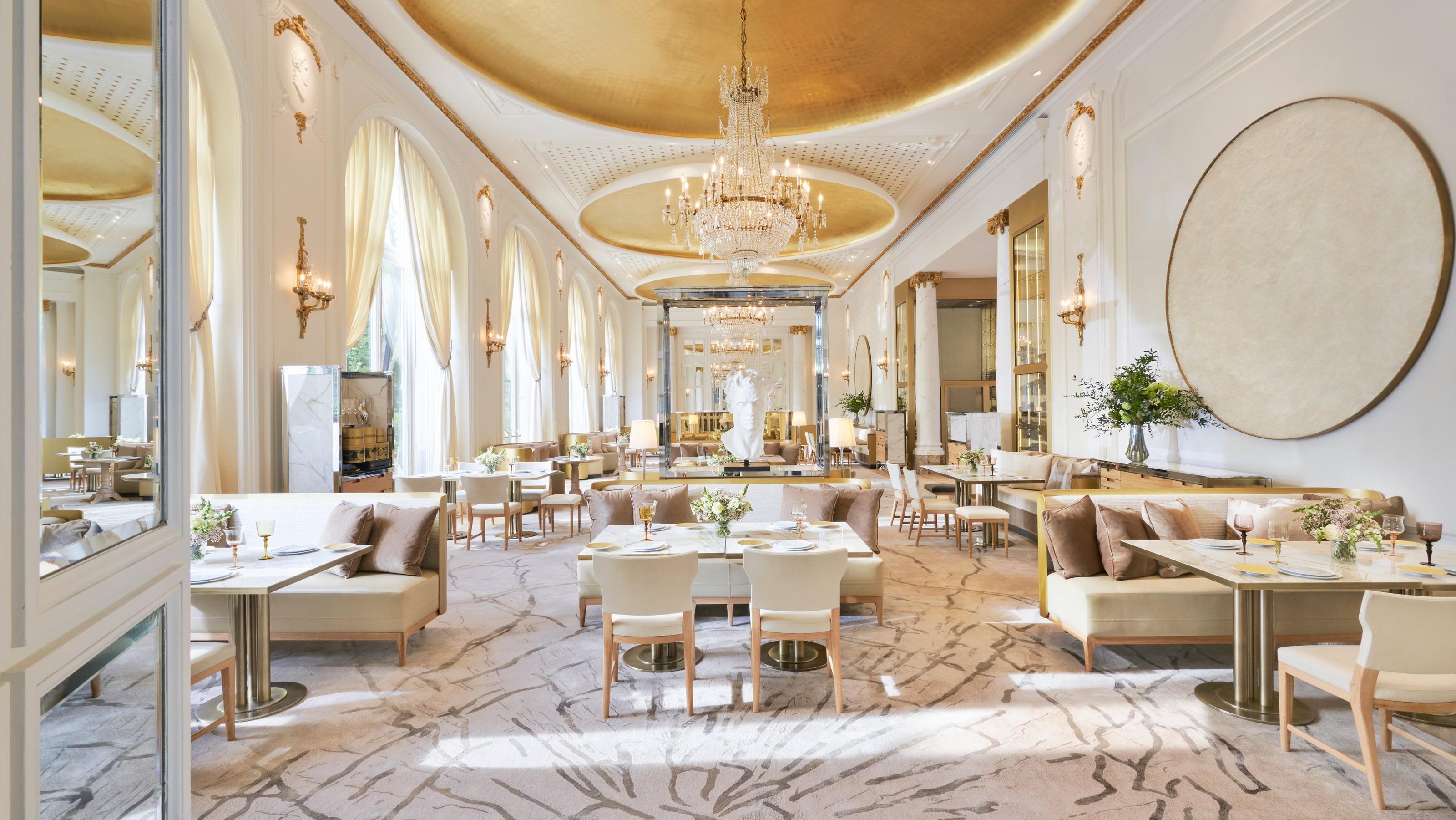 Grand Belle Époque dining room with gilt ceiling and crystal chandeliers