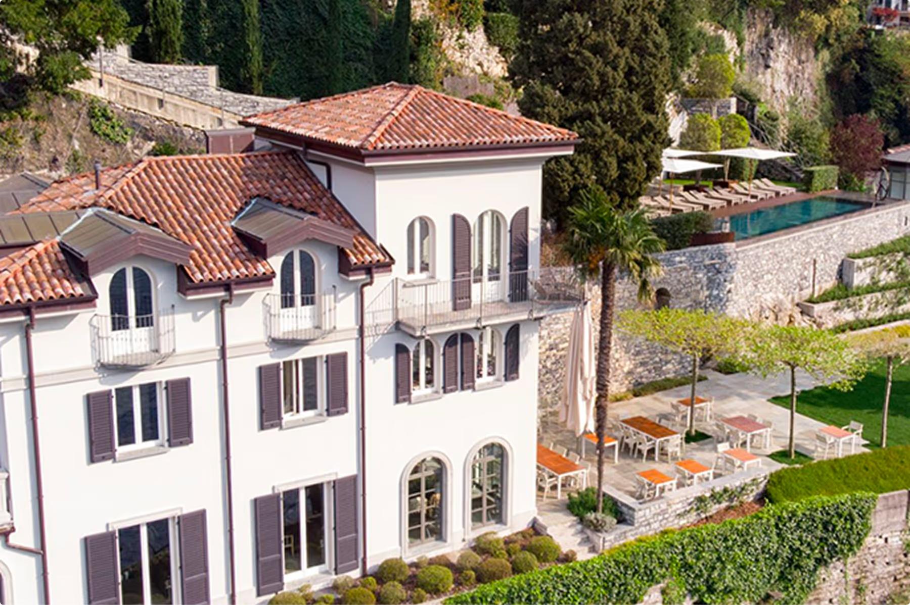 Villa Làrio: whitewashed villa on hillside surrounded by landscaped grounds
