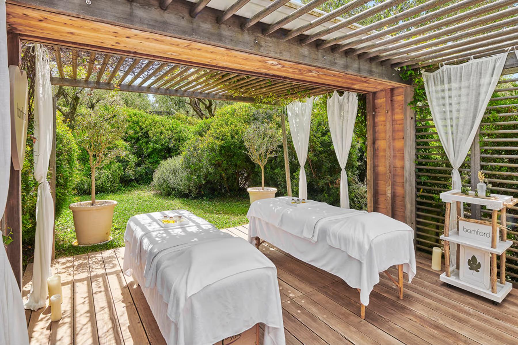 Spa treatment room with therapist and client on massage bed