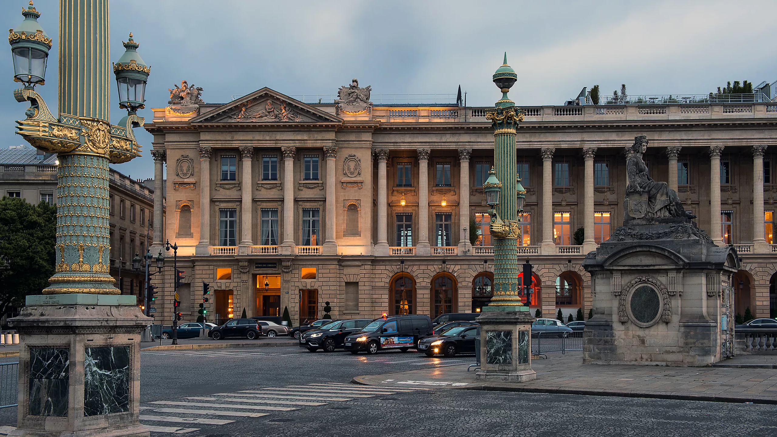 Hôtel de Crillon: building facade illuminated at dusk on Paris street corner with classical proportions