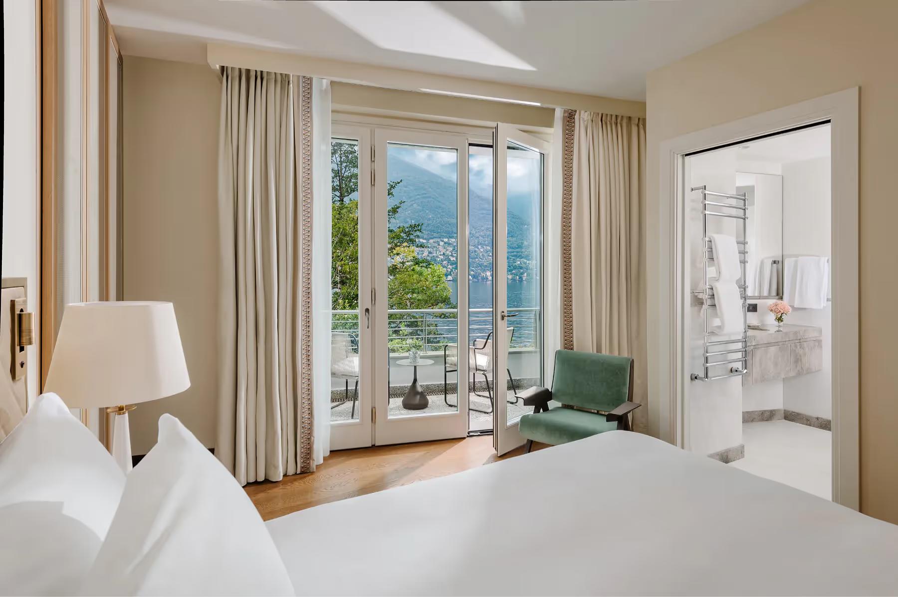 Mandarin Oriental, Lake Como: guest suite with bed, cream furnishings, and balcony overlooking lake and peak