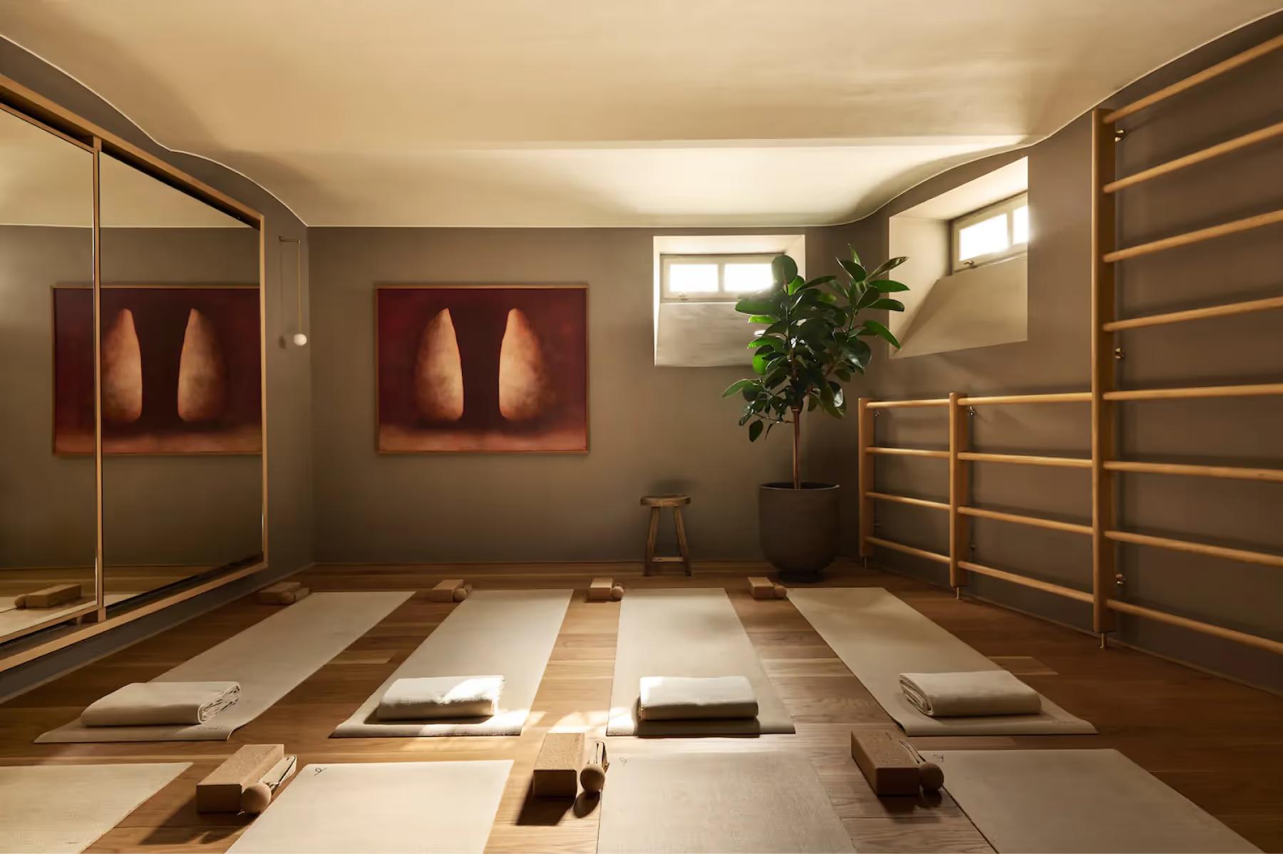 A spa hammam room with heated platforms, arched niches, and indirect lighting