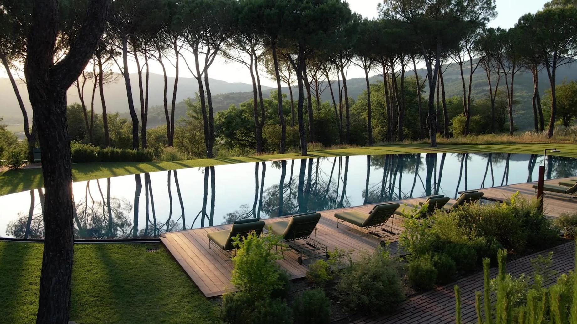 An infinity pool among umbrella pines on an Umbrian hillside