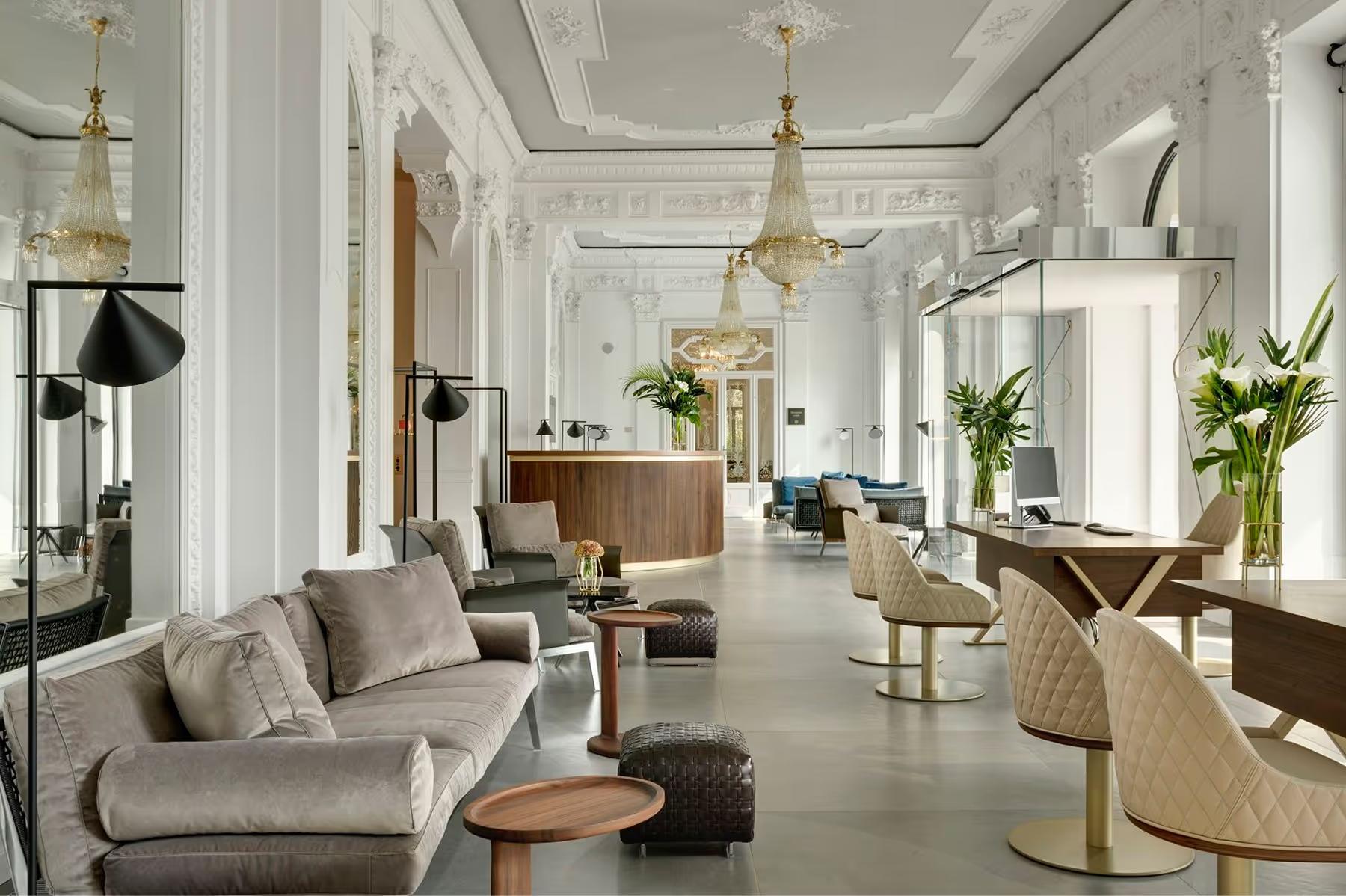 Grand Hotel Victoria Concept & Spa: a bright interior hallway with cream walls, plants, and pendant lighting