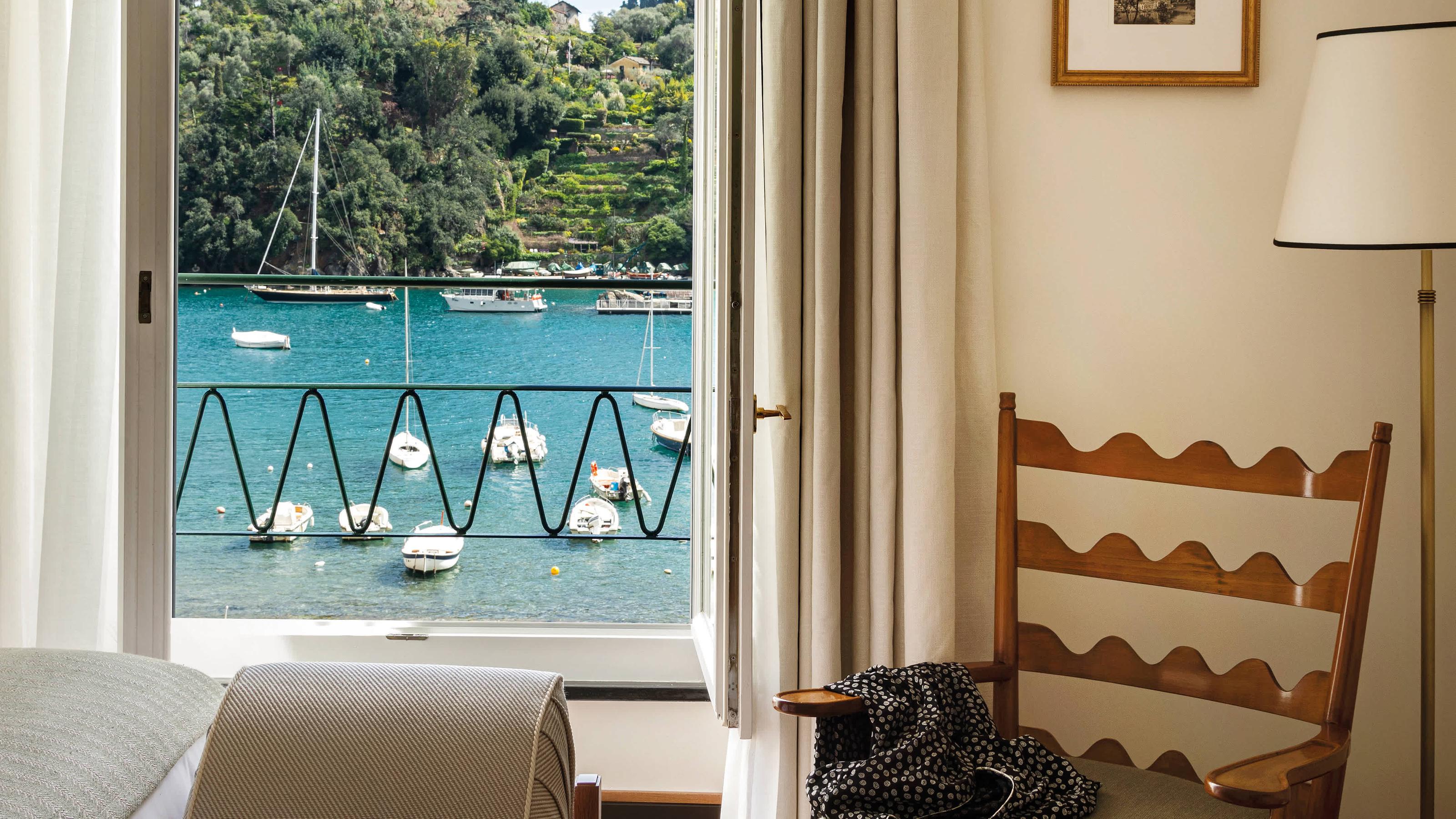 A room with sea-view terrace overlooking boats in Portofino’s harbor