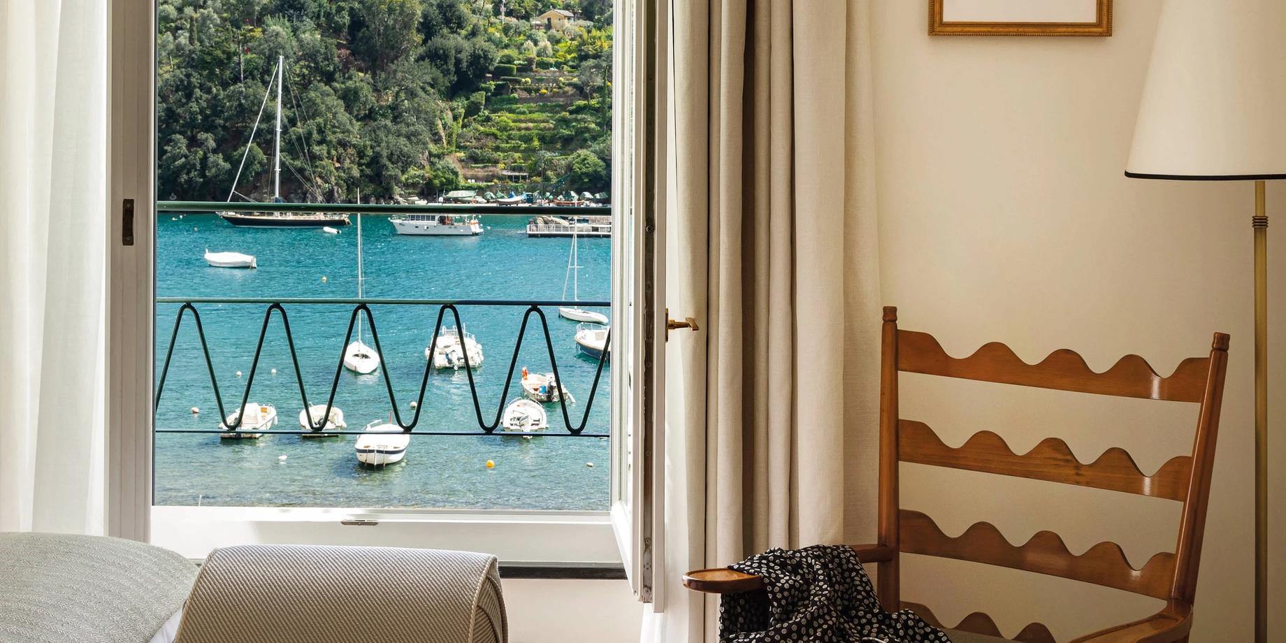 A room with sea-view terrace overlooking boats in Portofino’s harbor