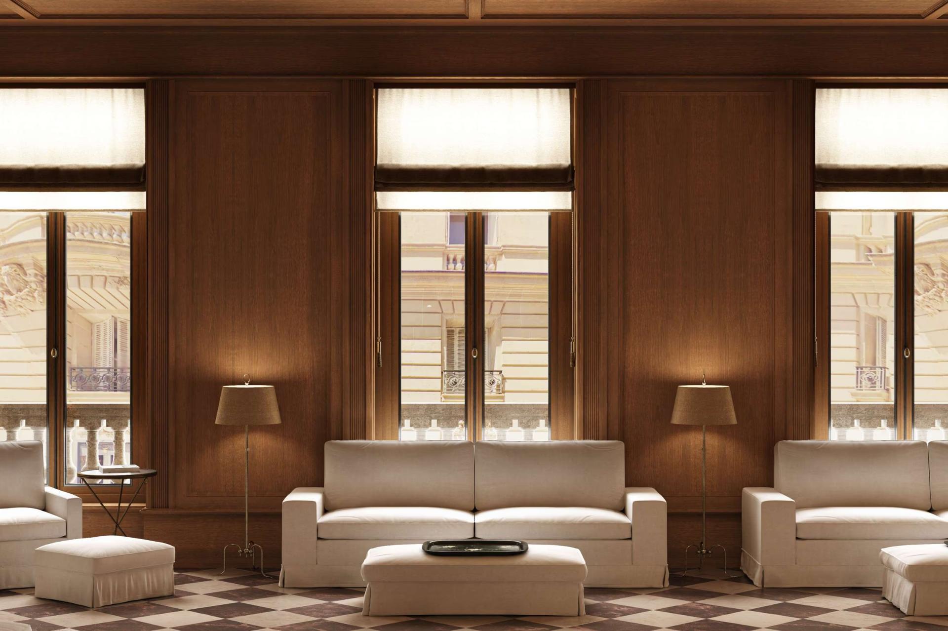 A wood-paneled living room with cream seating and art on the walls