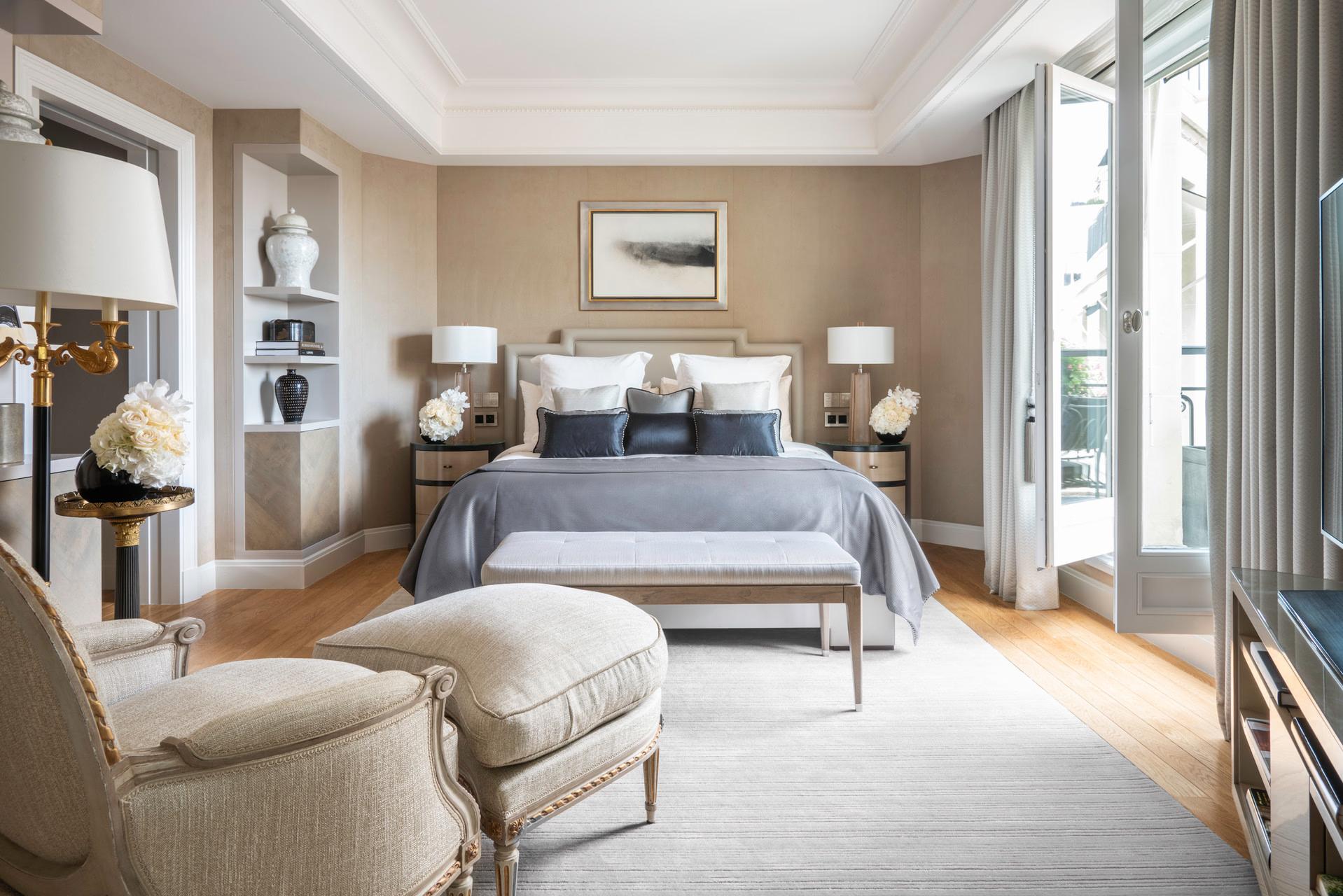 Four Seasons Hotel George V: a spacious suite with light wood floors, white furnishings, and tall windows