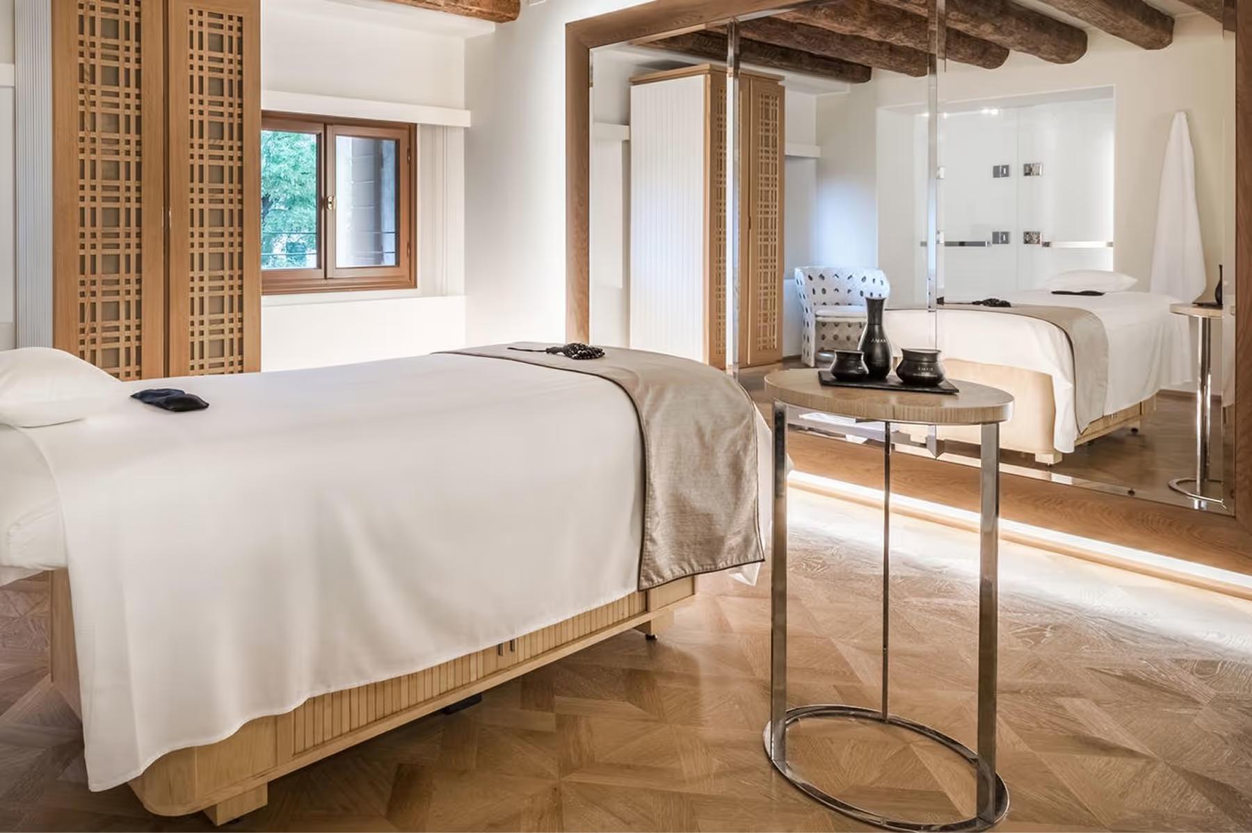 Aman Venice: a fitness center with wooden beams, exercise equipment, and bright open space
